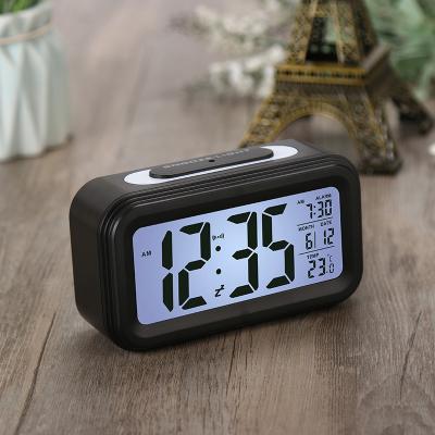 China Smart Calendars LCD Digital Alarm Clock with LED Backlight Sensor Touch LED Clock with Time-Temperature Date for sale