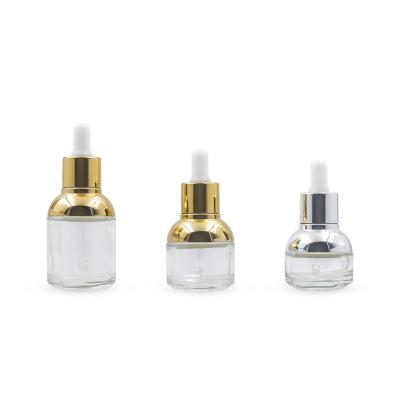 China Fashion Cosmetic Gold Plating 30ml Dropper Whitening Essence Glass Bottle Cosmetic Packaging for sale