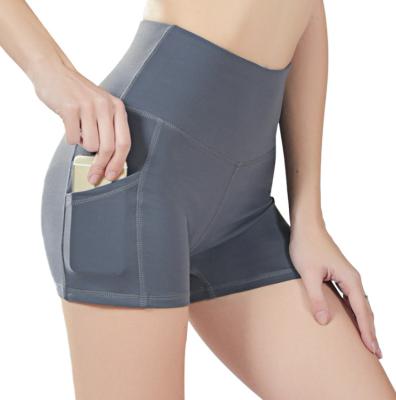 China Solid Color Breathable Yoga Shorts High Waist Sports Tight Shorts For Women With Pockets for sale