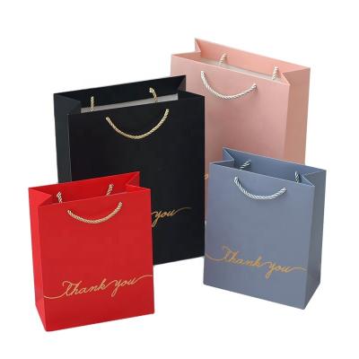 China Hot Wholesale Recyclable High Quality Logo Craft Paper Bag Art Paper Shopping Gift Gold Foiled Paper Bag With Rope Handle for sale