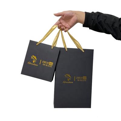 China Recyclable Wholesale Custom Printed Matte Black Luxury Shopping Gift Paper Bag Gold Stamping With Handle for sale