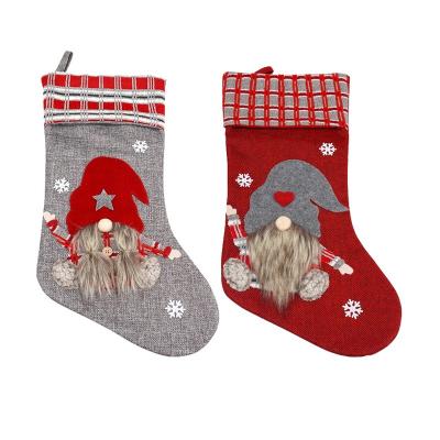 China Red non-woven fabric Santa Decorations Christmas stockings and gray stocking minions ornament minions Christmas Jurassic Christmas for sale