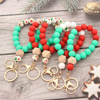 China Women Anti-lost Colorful Wooden Beaded Ring Fashion Bag Pendant For Key Chain Bracelet Santa Print Silicone Wooden Beads Christmas Silicone for sale