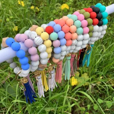 China Elastic Key Ring For Women Gift Candy Color Silicone Bracelet Bangle Key Chain Bag Tassel Leather Pendant Beaded Wooden Beaded PU for sale