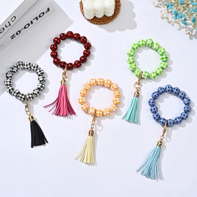 China New Plaid Beads Key Chain Colorful Wooden Beads Bracelet With PU Leather Tassel Pendant For Women Christmas Bracelet Key Ring Keyring for sale