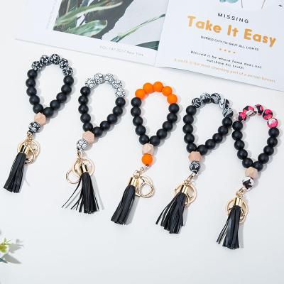 China Silicone Beads Halloween Skeleton Print Silicone Beads Bangle Bracelet Key Chain With PU Leather Tassel Smiley Face Bangle Keyring for sale