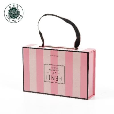 China Handmade Magnetic Box With Ribbon Closure Packing Boxes With Handles Luxury Gift Packaging Boxes For Skin Care Product for sale