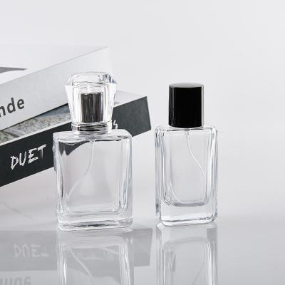 China 25ml 50ml cosmetic high quality flat square transparent glass perfume bottle with perfume lid for sale