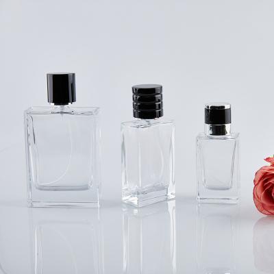 China Cosmetic factory flat square shape 30ml 50ml 100ml clear glass perfume bottle with black plastic cap for sale