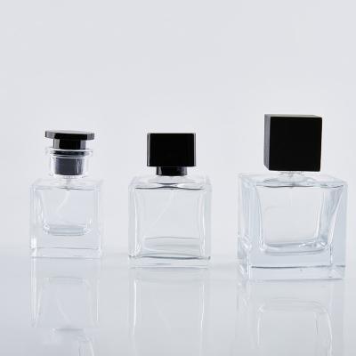 China Hot Sale 30ml 50ml 100ml Cosmetic Perfume Bottles Glass Spray Empty Perfume Bottle With Black Cap for sale