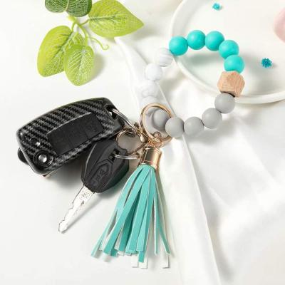 China Best Selling Stocked Silicone Bead Keychain PU Tassel Bracelet Wrist Pendant Bracelet Key Chain for sale