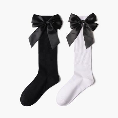 China Breathable Design Big Black Bowknot Design Breathable Midi Fashion Girls Teens White Cotton Socks Women Tube Socks for sale