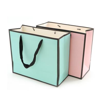 China Pink Recyclable Square Gift Paper Bag With Handle Personalized Luxury Embossed Kraft Paper Food Bag for sale