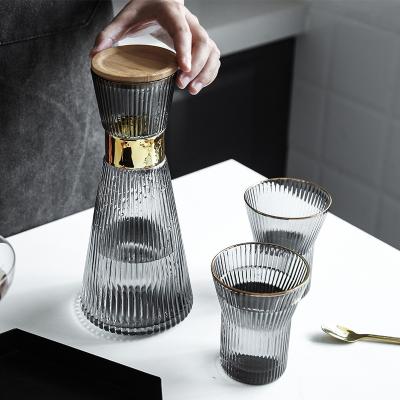 China Sustainable Top Seller Carafe Thickened Bottom Glass Pitcher Jug Vertical Stripes Ribbed Glass Water Carafe Bamboo Lid with Gold Decor for sale