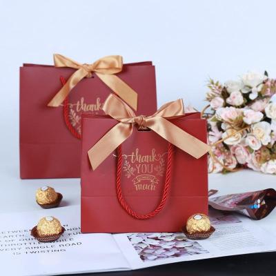 China Recycled Materials Logo Design Luxury Custom Jewelry Packaging With Ribbon Handles Small Gift Wrapping Paper Bag for sale