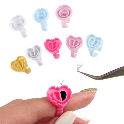 China For Lash Extension Or Other Beauty Uses Stick Rings 100pcs Heart Shape Eyelash Extension Disposable Finger Holder New Rings Cup For Eyelash Extension Tattoo Pigment for sale