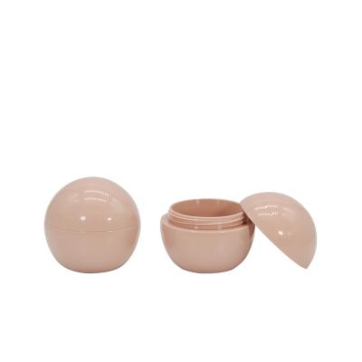 China Custom Pink Cream Bottle Ball Shaped Mini Makeup Case Bpa Packaging Tube Plastic Compact Free Cream Jar Cosmetic Container for sale