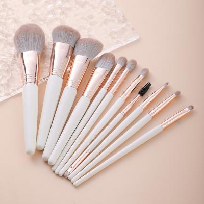 China Angular Blush Custom Logo 11 Piece Gold And White Wood Makeup Brush Set for sale