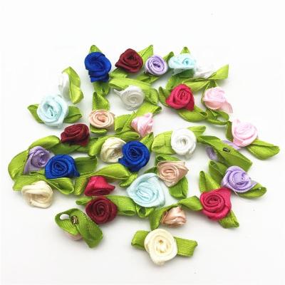 China Eco-firendly 50pcs/bag Mini Satin Ribbon Rose Buds Flowers with Green Leaves Opens Wedding Confetti Embellishments for sale