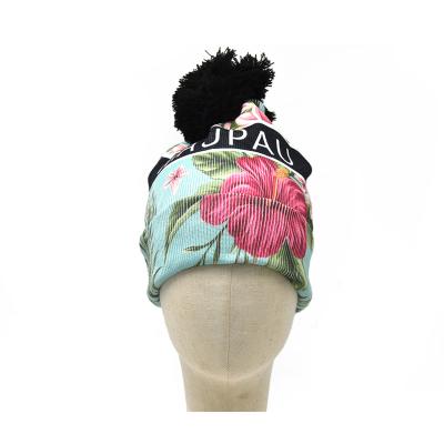 China Custom Winter COMMON Hats Acrylic Folded Digital Printing Floral Pom Pom Flower Beanie Hat For Women for sale