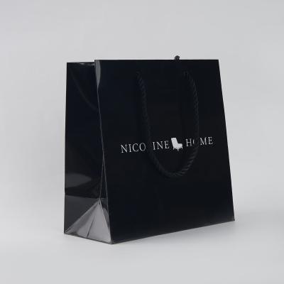 China Recyclable Luxury Black Customizable Shopping Gifts Bags Gift Wrapping Kraft Paper Bag Custom Logo for sale