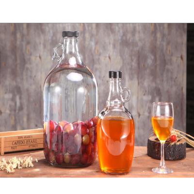 China Wholesale 1liter 2liter Amber Glass Price Growler Beer Good Quality Wine Whiskey Bottle With Metal Screw Lid for sale