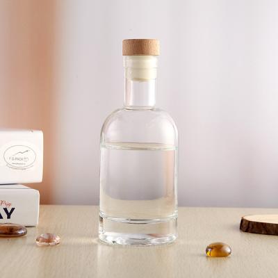 China 100ml Transparent Round Glass Bottle Spirit Bottle Glass Disposable Liquor Bottle With Alu Wood Cork for sale