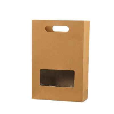 China Recyclable new window style holed kraft paper bag gift bag stock thickened simple packaging fashion gift bag for sale