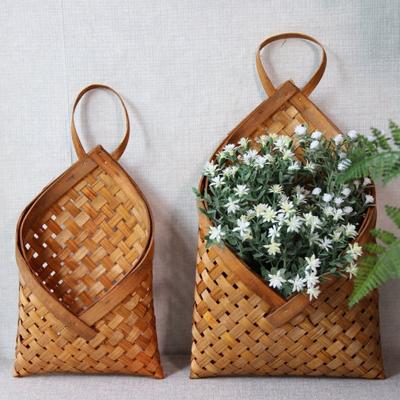 China 2021 Sustainable Natural Wicker Bamboo Rattan Woven Wall Hanging Basket Kitchen Wall Decoration Basket Storage for sale