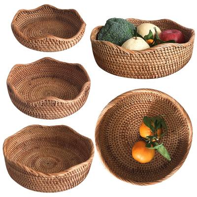 China Hand - 2021 Round Rustic Handwoven Woven Rattan Fruit Wicker Basket Storage Serving Tray For Picnic Home Decors for sale