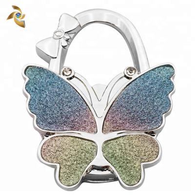 China Promotional Gifts Shimmer Powder Glitter Butterfly Shaped Portable Folding Purse Handbag Hook Bag Hanger for sale