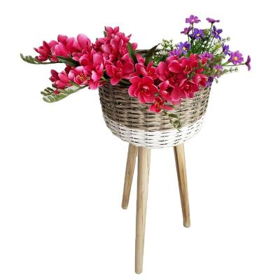 China Fashion Minimalist Wholesale Hand - Woven Flowerpot PE Rattan Flowerpot With Wooden Leg Freestanding Outdoor Flower Basket for sale