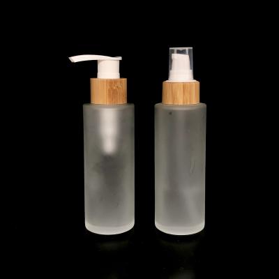 China Eco drink frosted/clear/black bamboo pump/100ml spary/dropper glass bottle cosmetic packaging for cream for sale