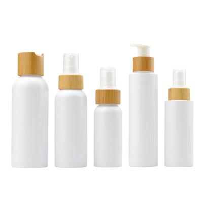 China Custom Logo Capacity Color Cosmetic Skincare Lotion Bottles Plastic PET Lotion Pump Bottle With Bamboo Lid for sale