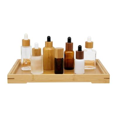 China Serum cosmetic glass bottle with bamboo dropper glass frosted bottles with bamboo dropper lid for sale