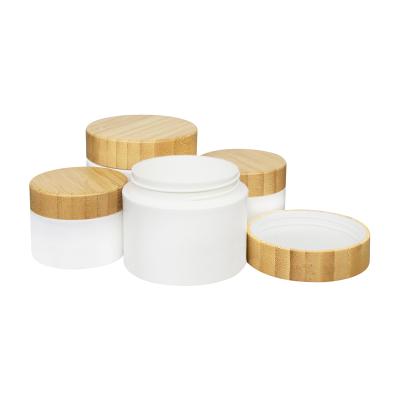 China Double Wall Wholesale 8oz Bamboo Jar Round Shape Bamboo Cosmetic Packaging With Engraved Lid for sale