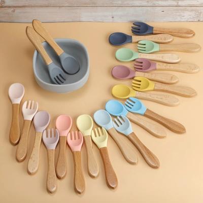 China 2pcs Viable Baby Soft Silicone Spoon Candy Color Safety Baby Learning Wooden Spoon Fork Children Boy Girl Non-Slip Food Feeding Tool for sale