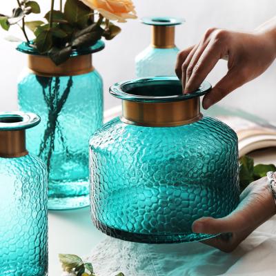 China Eco-friendly home decoration flower lake dining table new design green glass vase pot with copper ring for sale