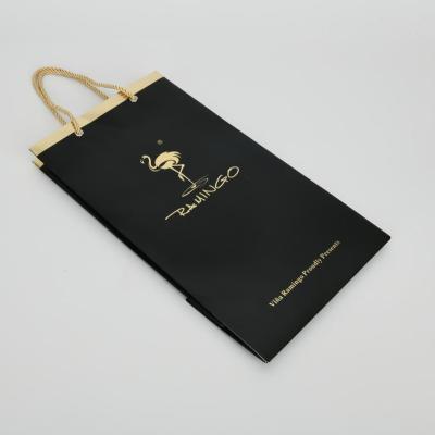 China Recycled Materials Customized Logo Luxury Gold Foil Printed Black Paper Bag For Gift Packaging Wine With Handle for sale