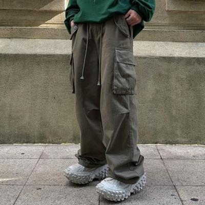 China Anti-wrinkle OEM Streetwear Baggy Cargo Trousers WIth Side Pocket Custom 100% Cotton Drawstring Wide Leg Plain Men Cargo Pants for sale