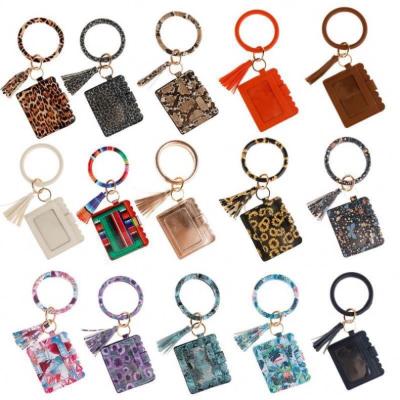 China Wholesale Daily Life Christmas Monogram Bracelet Wristband Key Chain ID Credit Card Holder with Tassel Leather Wristband Key Chain Wallet for sale