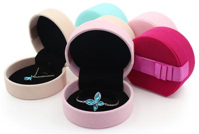 China Colorful Faux Suede Jewelry Velvet Box Round Shaped Wedding Ring Box With Ribbons for sale