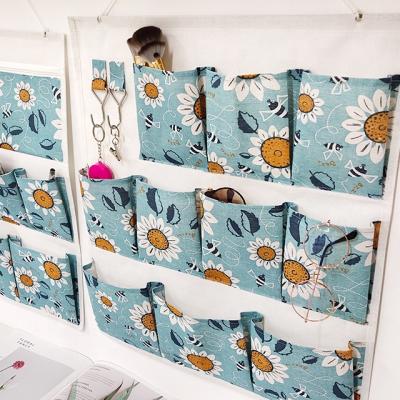 China OEM Custom Small Daisy Folding Multi-pocket Organizer Wall Hanging Storage Bag For Family Life for sale