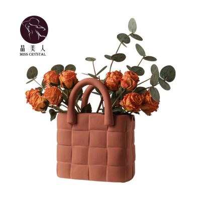 China Retro Bohemian Creative Ceramic Carved Flower Vase Handbag For Wedding Props Event Party Stage Decoration for sale