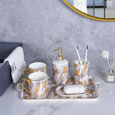 China Luxury Morden Gold Bathroom Decor Luxury Accessories Set With Lotion Bottle Toothbrush Holder Gargle Cup Soap Dish for sale