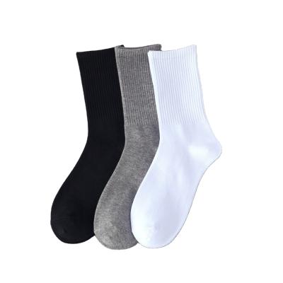 China Viable high quality cheap stock solid color knitted plain black and white gray socks cotton crew socks for sale