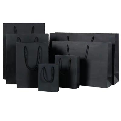 China Stock low cost flat bottom handle black bioldegradable paper bag recyclable with logo for shopping for sale