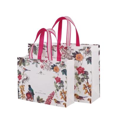 China Handled Non Woven Stock White Bags With Flower And Birds Printing For Cloth Store for sale