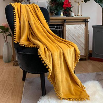 China Anti-pilling Flannel Blanket With Pompom Fringe Light Cozy Bed Blanket Soft Throw Blanket Tassel for sale