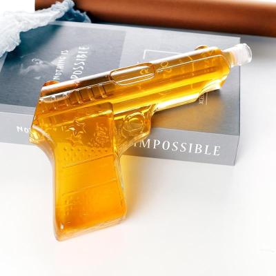 China Hot Selling Beverage Gun Shaped Clear High Borosilicate Bottle 500ml Hand Gun Bottle For Liquor/Wine for sale